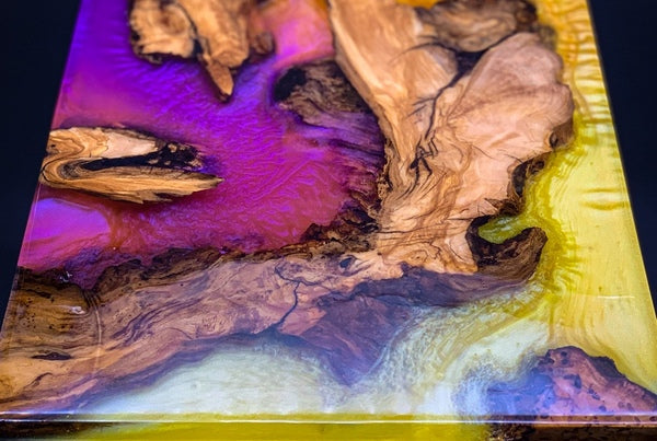 An epoxy resin tray made with wood, Pigmently pigments, and epoxy resin.