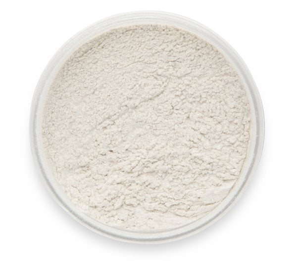 A container of Comet Tail Dust Mica Powder, seen from above with the lid removed to show the texture.