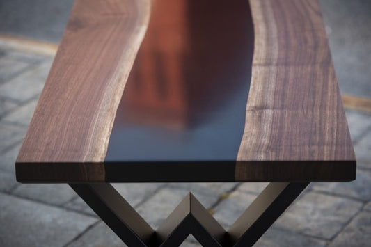 An epoxy coffee table with a brown-dyed epoxy river vein.