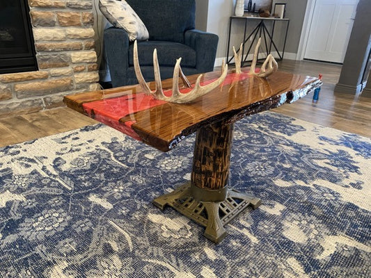 An epoxy river table, featuring an epoxy resin vein infused with Watermelon Red Mica Powder by Pigmently.