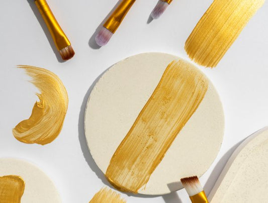 Paint strokes made with a gold pigmented paint.