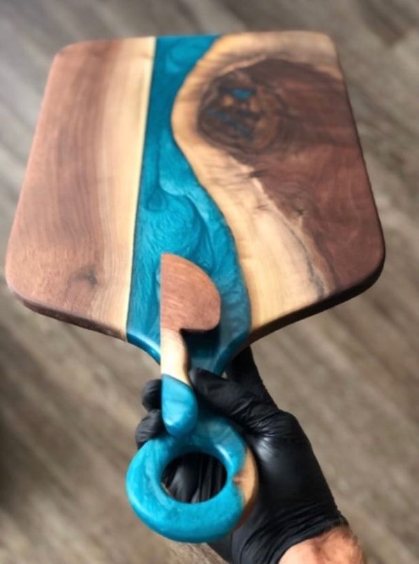 An epoxy resin charcuterie board made with a light blue epoxy pigment.