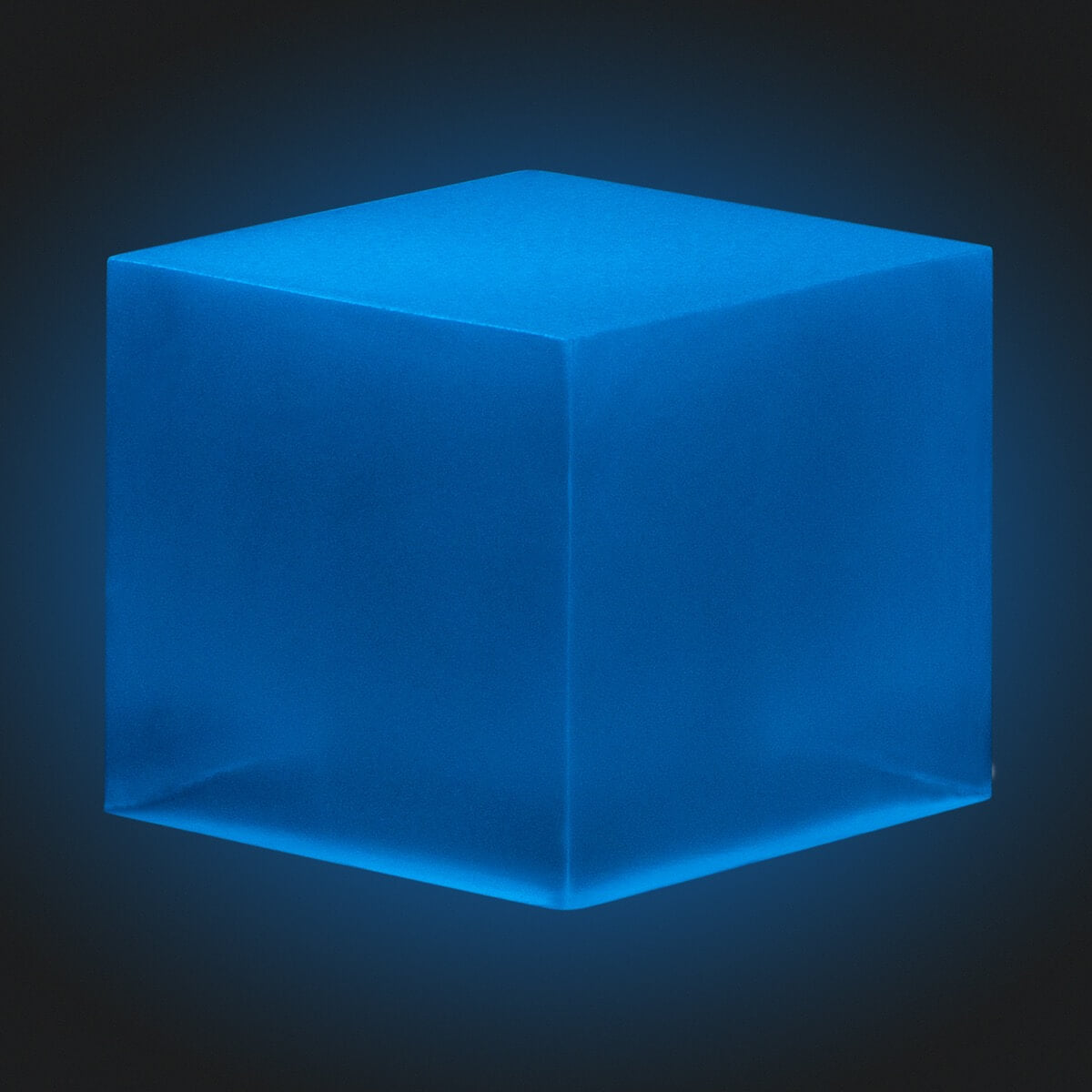 A resin cube made with the Sky Blue Glow in the Dark Mica Powder Pigment by Pigmently, seen in a dark environment to showcase the glow effect.