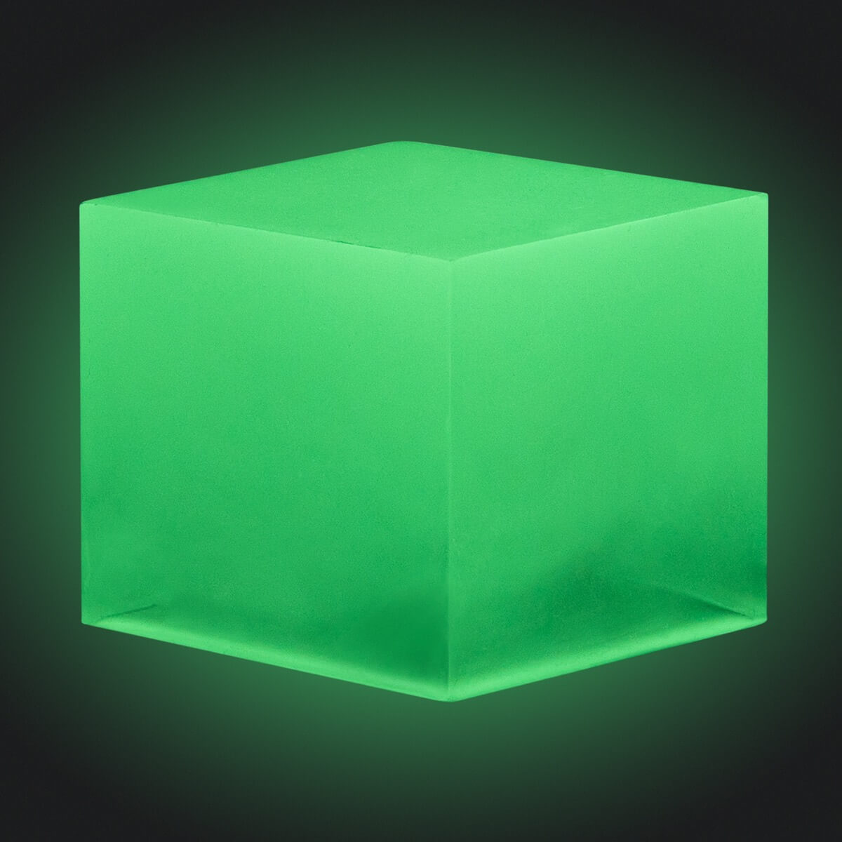 A resin cube made with the Yellow Green Glow in the Dark Mica Powder Pigment by Pigmently, seen in a dark environment to showcase the glow effect.